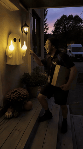 Glowing ghost wall light surprising a visitor